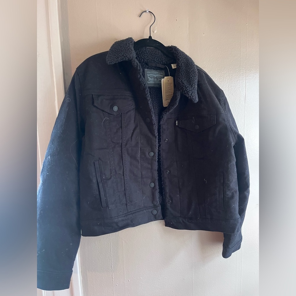 Black leather jean jacket lined with wool.